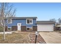 Newly remodeled home featuring blue siding and a two-car garage at 15934 E Columbia Pl, Aurora, CO 80013