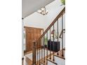 Inviting foyer with hardwood floors, staircase, and modern lighting fixtures at 5694 S Pagosa Ct, Centennial, CO 80015