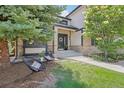 Inviting home featuring chairs on the front lawn with a wreath hanging on the black front door at 9810 Venneford Ranch Rd, Highlands Ranch, CO 80126