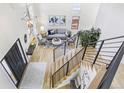 Open-concept living room with high ceilings, modern lighting, and a staircase with metal railings at 9810 Venneford Ranch Rd, Highlands Ranch, CO 80126