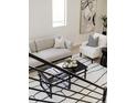 Living area showcasing modern furniture, including a sofa, chair, and a coffee table with a black and white rug at 1390 S Jasmine Way, Denver, CO 80224