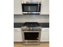 Stainless steel KitchenAid microwave and range at 21242 E 63Rd Dr, Aurora, CO 80019