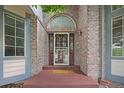 Welcoming front entrance with a decorative door, brick facade, sidelights, and 'Welcome' mat at 6506 S Robb Way, Littleton, CO 80127