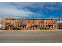 Brick apartment building with street view and partially bare trees on a clear day at 2306 Glenarm Pl # 206, Denver, CO 80205