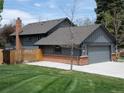Beautiful home with a spacious yard, wooden fence, and brick chimney creates a cozy, inviting atmosphere at 5973 S Krameria St, Centennial, CO 80111