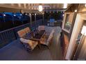Outdoor deck featuring ample seating with colorful cushions, a dining table, grill, and string lights at 5973 S Krameria St, Centennial, CO 80111