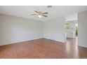 Cozy living room featuring hardwood floors, neutral paint, and open access to the kitchen at 2453 S Memphis Way, Aurora, CO 80013