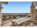 Enjoy outdoor dining on this beautiful deck with a table set and stunning community views at 14734 Domino Dr, Parker, CO 80134