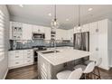 Bright kitchen with stainless steel appliances, subway tile backsplash, and island with seating at 14734 Domino Dr, Parker, CO 80134
