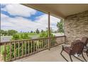 View from the covered front porch, showcasing outdoor seating and a glimpse of the surrounding green space at 5483 Gunnison Dr, Frederick, CO 80504
