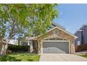 Charming two-story home with stone facade, well-maintained lawn, and inviting curb appeal at 19157 E Progress Ave, Centennial, CO 80015