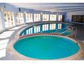 Indoor pool and hot tub area with natural lighting and ample space, perfect for year-round enjoyment at 1300 S Parker Rd # 110, Denver, CO 80231