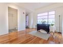 Bright living area with hardwood floors, natural light from a large window, and a cozy bathroom nearby at 722 W 6Th Ave, Denver, CO 80204