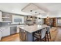 Spacious kitchen with granite island, stainless steel appliances and hood at 5537 Lake Gulch Rd, Castle Rock, CO 80104