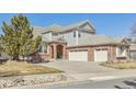 Beautiful two-story home featuring a three-car garage and a well-maintained yard with mature trees at 6503 S Quemoy Way, Aurora, CO 80016