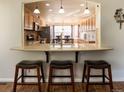 Open kitchen featuring granite countertops, pendant lighting, and seating at the breakfast bar at 1128 S Duquesne Cir, Aurora, CO 80018