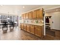 Spacious kitchen with ample cabinetry, countertop space and an adjacent dining area at 1128 S Duquesne Cir, Aurora, CO 80018