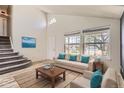 Bright living room featuring a vaulted ceiling, a large window, and neutral-colored furniture with blue accents at 6382 Freeport Dr, Highlands Ranch, CO 80130