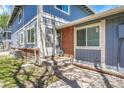 Close-up of a welcoming entrance with a decorative wreath on the door, showcasing brick accents and a well-kept exterior at 1287 S Wheeling Way, Aurora, CO 80012