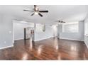Spacious living room features hardwood floors, ceiling fans, and neutral walls offering a bright and airy atmosphere at 206 Cedar St, Hudson, CO 80642