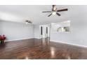 Open living room boasts wood floors, ceiling fans, open access to kitchen with great flow for entertaining guests at 206 Cedar St, Hudson, CO 80642