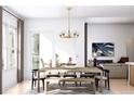Bright dining area with a stylish chandelier, table, and chairs, next to the living room at 2021 Grayside Cir, Castle Rock, CO 80109