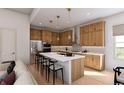 Bright, modern kitchen with stainless steel appliances, white countertops, and wood cabinets at 2021 Grayside Cir, Castle Rock, CO 80109
