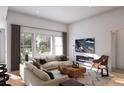 Cozy living room with large windows, hardwood floors and a modern fireplace at 2021 Grayside Cir, Castle Rock, CO 80109