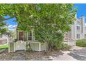 Charming home with light green siding, a quaint gated porch, and mature landscaping at 5750 W Atlantic Pl, Lakewood, CO 80227