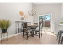 Dining area featuring a chandelier and sliding door access to the backyard at 15875 E Custer Dr Dr, Aurora, CO 80017