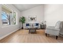 Bright living room with vaulted ceilings, a large window, and neutral decor at 15875 E Custer Dr Dr, Aurora, CO 80017