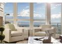 Cozy sitting area with chairs, large windows and beautiful views of mountains and sky at 5455 Landmark Pl # 1009, Greenwood Village, CO 80111