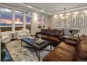 Bright and airy living room with a brown leather couch, stunning views, and ample natural light at 5455 Landmark Pl # 1009, Greenwood Village, CO 80111