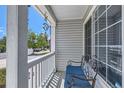 Relaxing front porch with a cozy seating area and views of the neighborhood street at 15685 E 50Th Ave, Denver, CO 80239