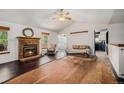 Bright living room features a brick fireplace and vaulted ceilings, offering a cozy and inviting space at 1572 W Long Ave, Littleton, CO 80120