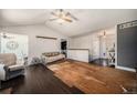 Open living room with vaulted ceilings and a partial view of the front entry at 1572 W Long Ave, Littleton, CO 80120