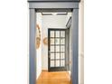 Bright entryway featuring hardwood floors, wainscoting, and a modern glass-paneled front door at 2939 Osceola St, Denver, CO 80212