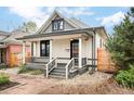 Charming home exterior featuring a covered porch, gray accents, and landscaped front yard at 2939 Osceola St, Denver, CO 80212
