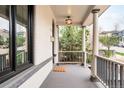 Inviting covered porch with stylish light fixture, gray accents, and space for seating at 2939 Osceola St, Denver, CO 80212