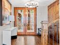 Elegant foyer with hardwood floors, glass doors, decorative chandelier, and staircase at 2063 Montane E Dr, Golden, CO 80401