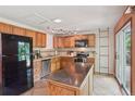 Well-equipped kitchen with wood cabinets, stainless steel appliances, and a center island at 2173 S Ouray St, Aurora, CO 80013