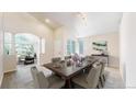 Elegant dining room with ample seating, neutral colors, and archway to living room at 2225 S Lima Ct, Aurora, CO 80014