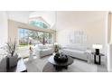 Bright living room with large windows, vaulted ceiling, and modern, minimalist decor at 2225 S Lima Ct, Aurora, CO 80014