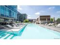 Inviting outdoor pool with lounge chairs, umbrellas, and clear blue water, perfect for relaxation at 4200 W 17Th Ave # 411, Denver, CO 80204