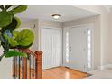 Bright foyer with hardwood floors, a white front door with sidelights, and a staircase with wood banister at 5708 S Galena St, Greenwood Village, CO 80111