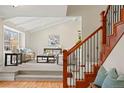 Inviting living room featuring a vaulted ceiling, large windows, and a staircase with wood banister at 5708 S Galena St, Greenwood Village, CO 80111