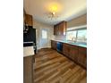Updated kitchen featuring wood cabinets, stainless steel appliances, and a bright window at 1435 N Uinta St, Denver, CO 80220