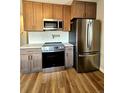 The kitchen showcases stainless steel appliances, granite countertops, and ample cabinet space at 1435 N Uinta St, Denver, CO 80220
