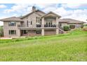 Expansive backyard featuring a large patio and deck, perfect for outdoor entertaining at 5881 Deer Meadow Trl, Golden, CO 80403
