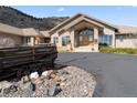 Beautiful exterior view of home, complemented by a circular drive and professional landscaping at 5881 Deer Meadow Trl, Golden, CO 80403